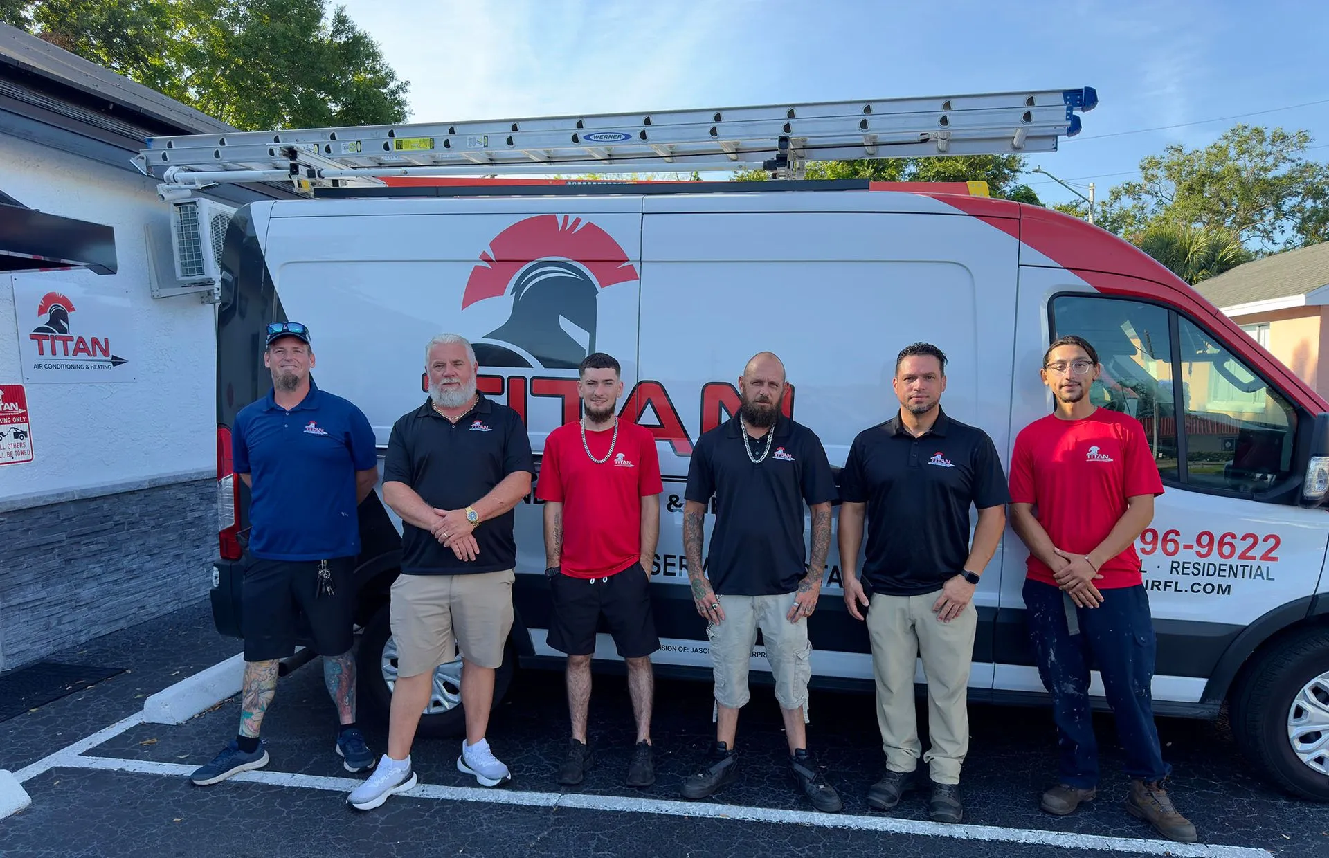 The Titan Air Conditioning and Heating team standing in front of their branded service vans in Winter Garden, Florida
